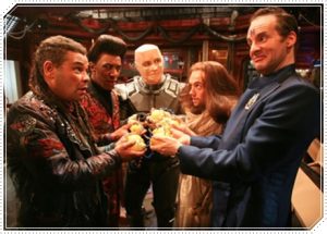 Rimmer, Lister, Cat, Kryten and Jesus hold an 8-volt battery fashioned from lemons.
